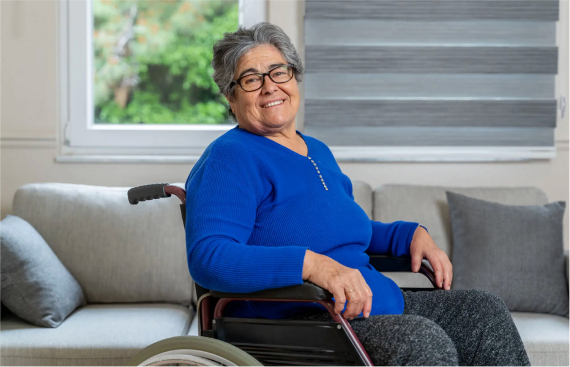 woman in blue top sitting in wheel chair